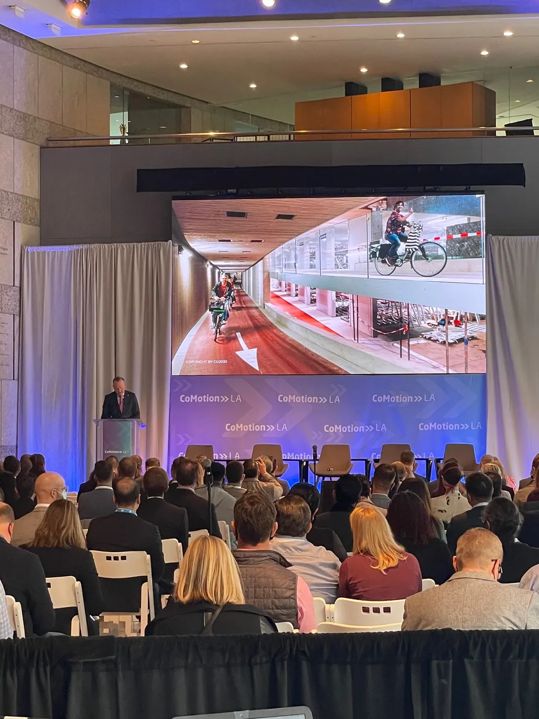 Presenter and large screen at an event in San Francisco